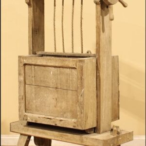 an antique piece of social history in the form of a rustic cheese press