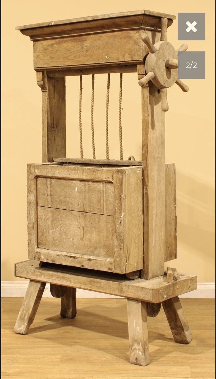 an antique piece of social history in the form of a rustic cheese press